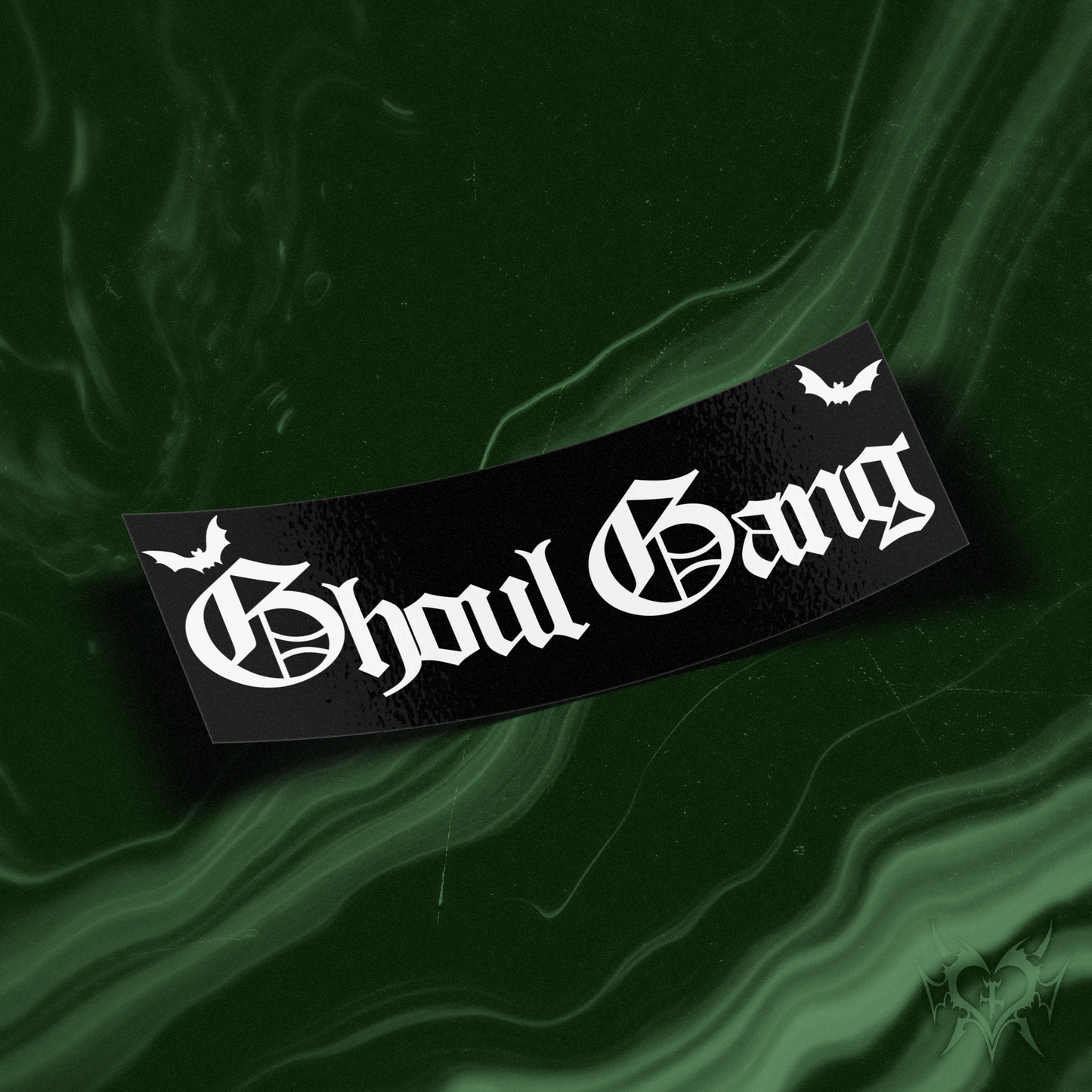 Ghoul Gang black slap sticker on dark green swirl store background, old english Ghoul Gang text with bats, Always Sick original GhoulGang design.